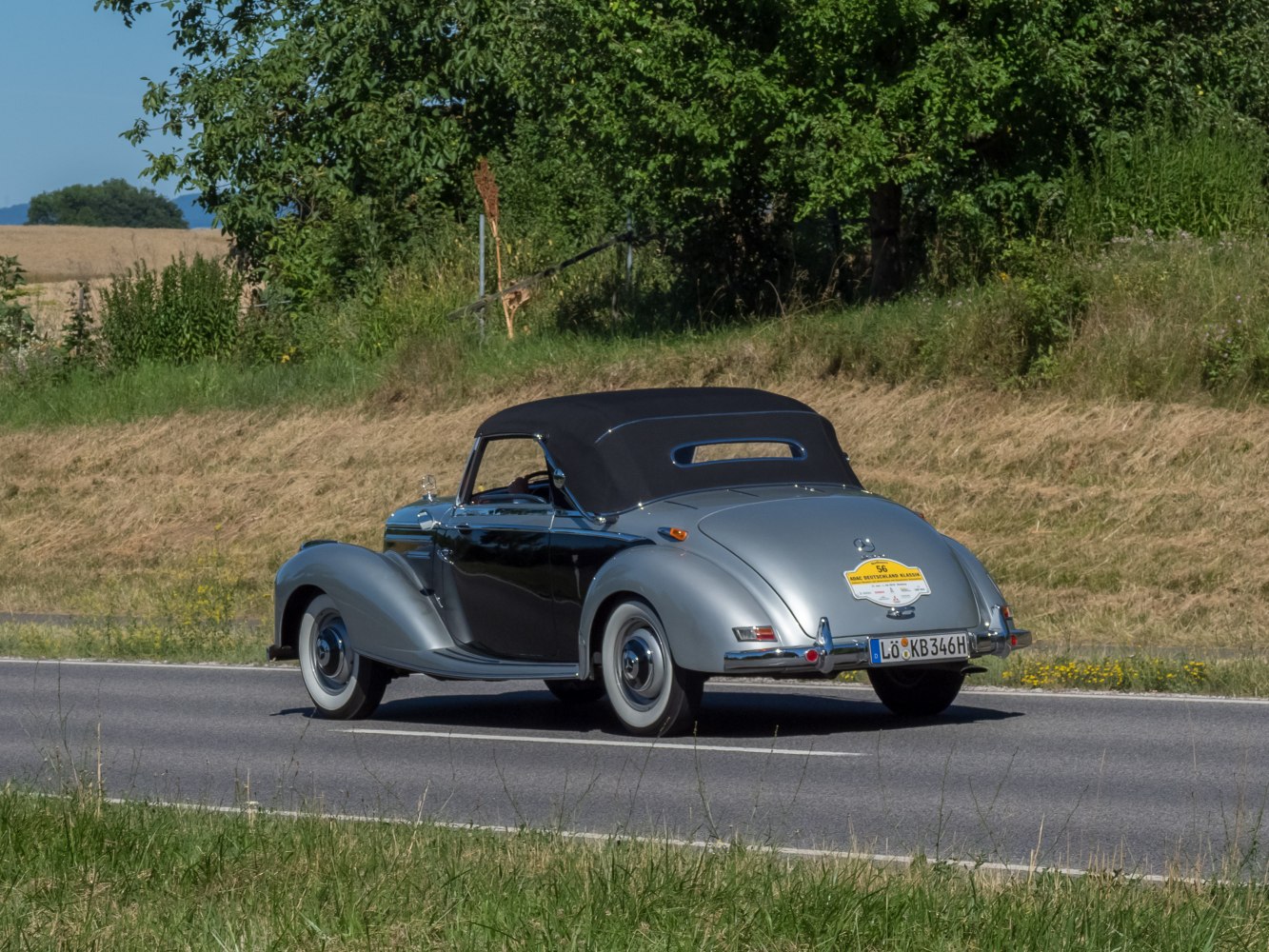 Convertible with closed soft top on a country road