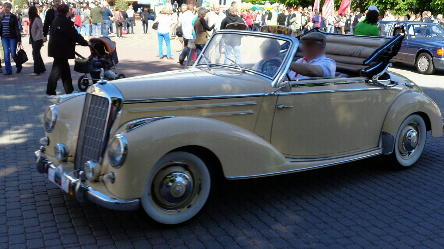 Vintage convertible with chrome grille and whitewall tires