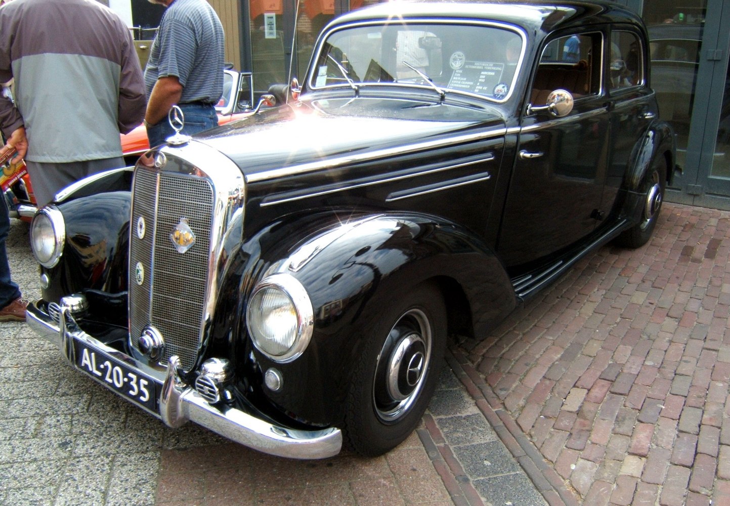 Vintage black sedan with chrome grille and rounded headlights