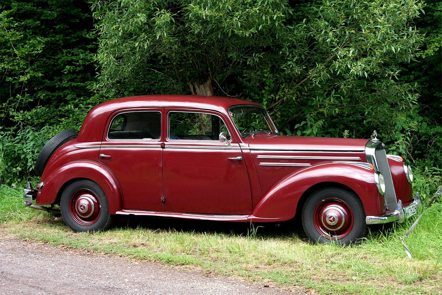 Classic sedan with rear spare tire and chrome exterior trim