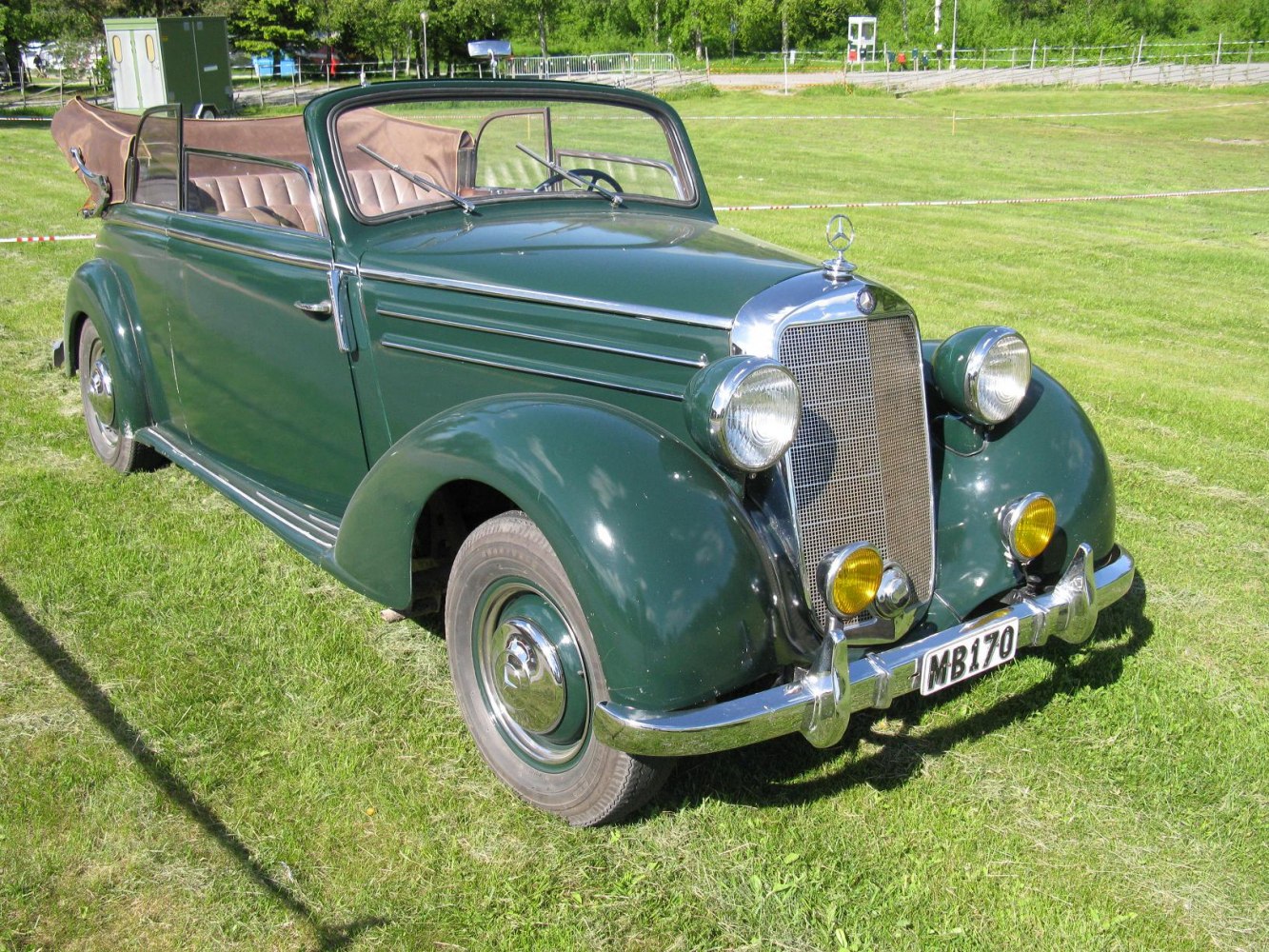 Vintage convertible with chrome grille and round headlights