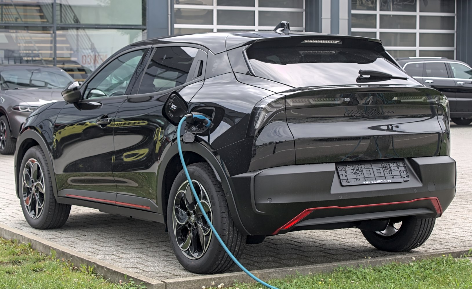 Electric SUV rear with charging cable and modern wheels