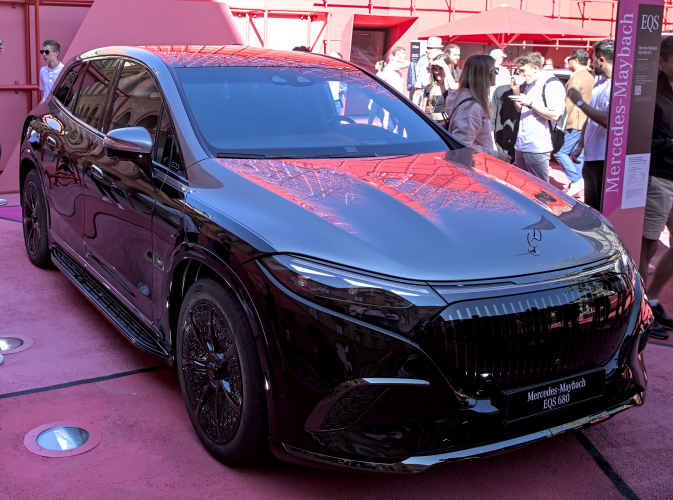 Sleek electric SUV with detailed grille and alloy wheels in front-side view