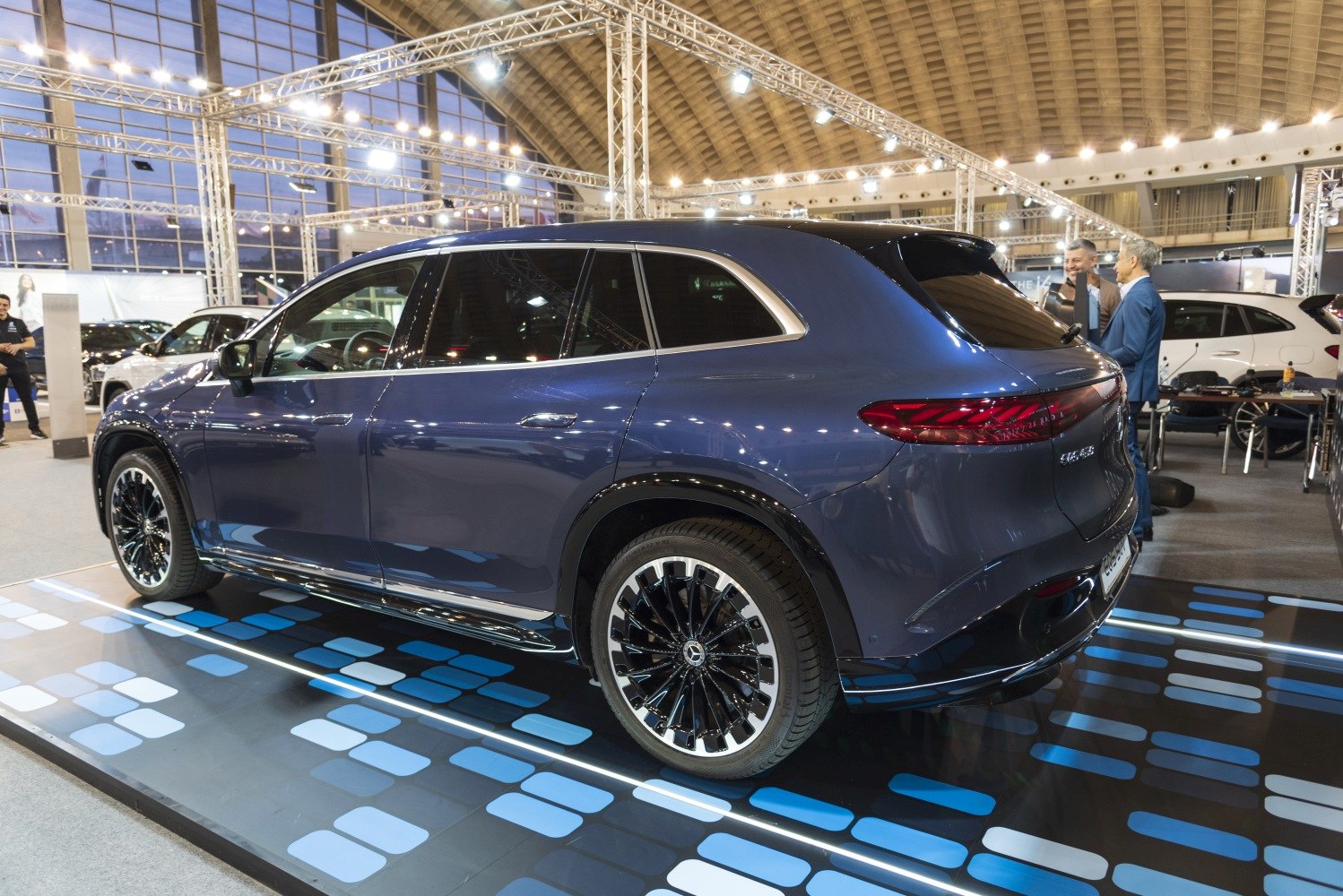 Rear and side view of a luxury electric SUV with LED taillights and multi-spoke wheels
