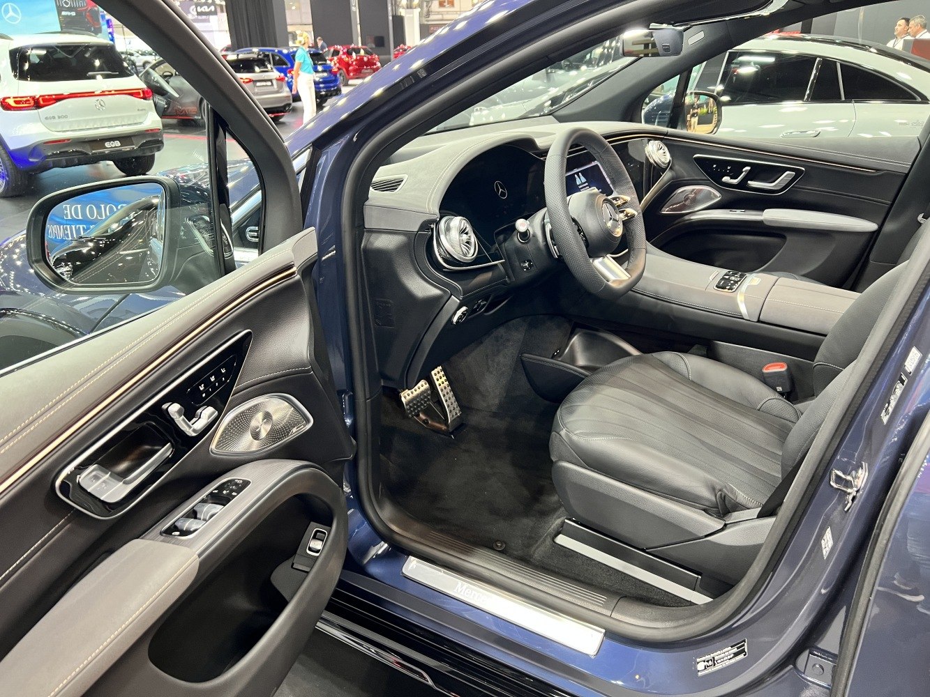 Driver side interior with steering wheel, seat, and door controls