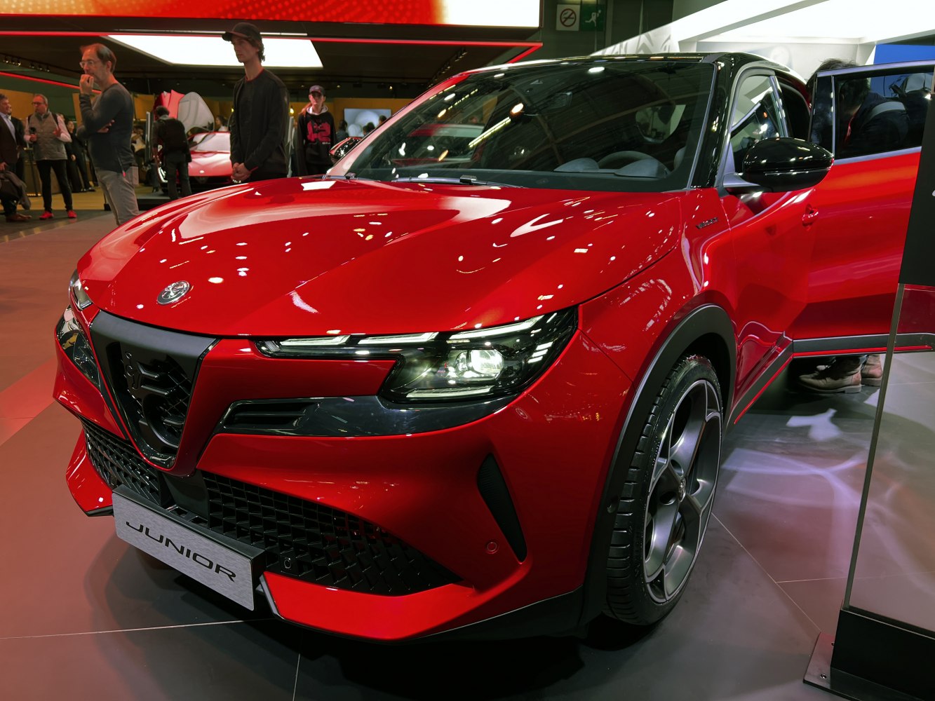 Red compact crossover with LED headlights and bold front grille