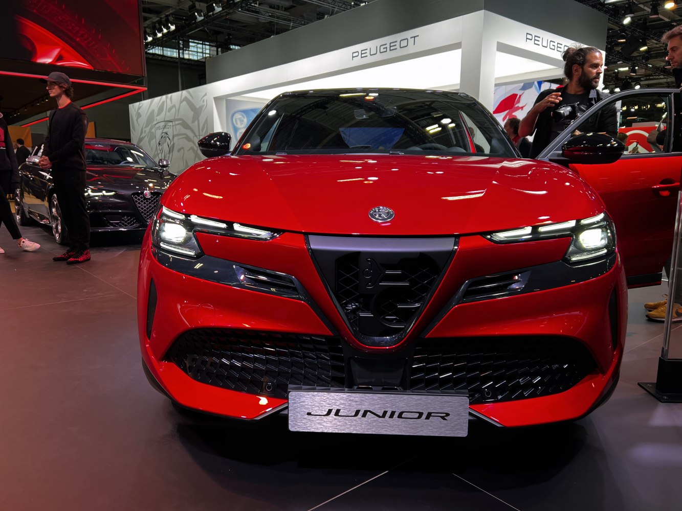 Front view of a modern sporty car with LED headlights and distinct grille