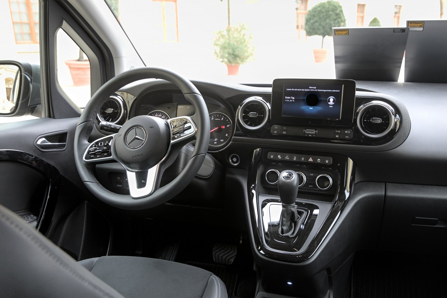 Dashboard with digital display, multifunction steering wheel, and gear shifter