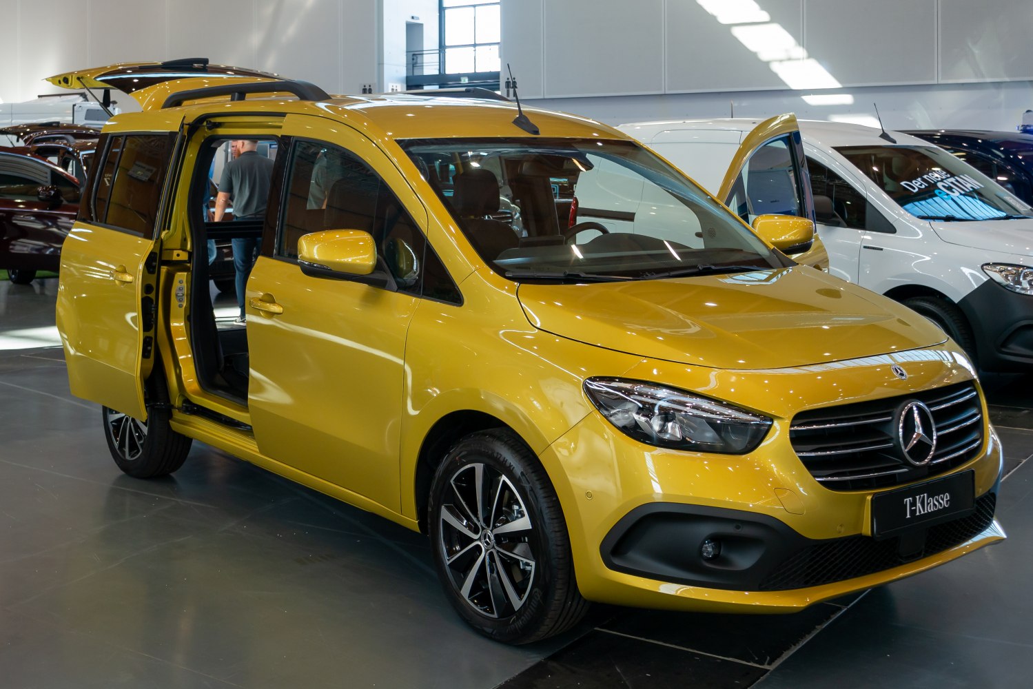 Yellow vehicle with sliding doors and alloy wheels