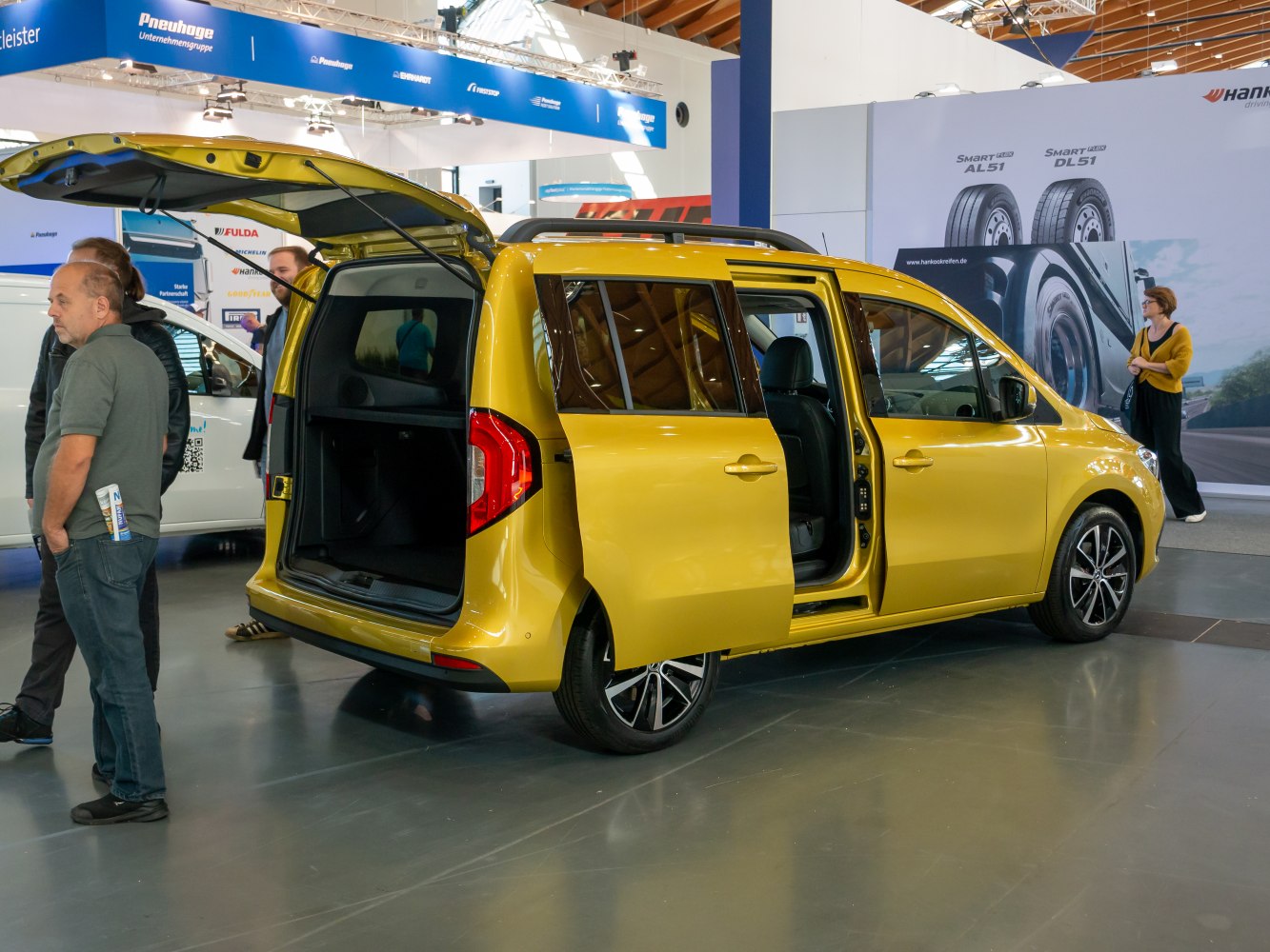 Yellow MPV with sliding side door and rear hatch open