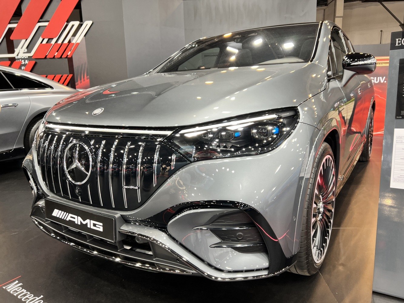 AMG front grille and LED headlight design, sleek SUV front details.