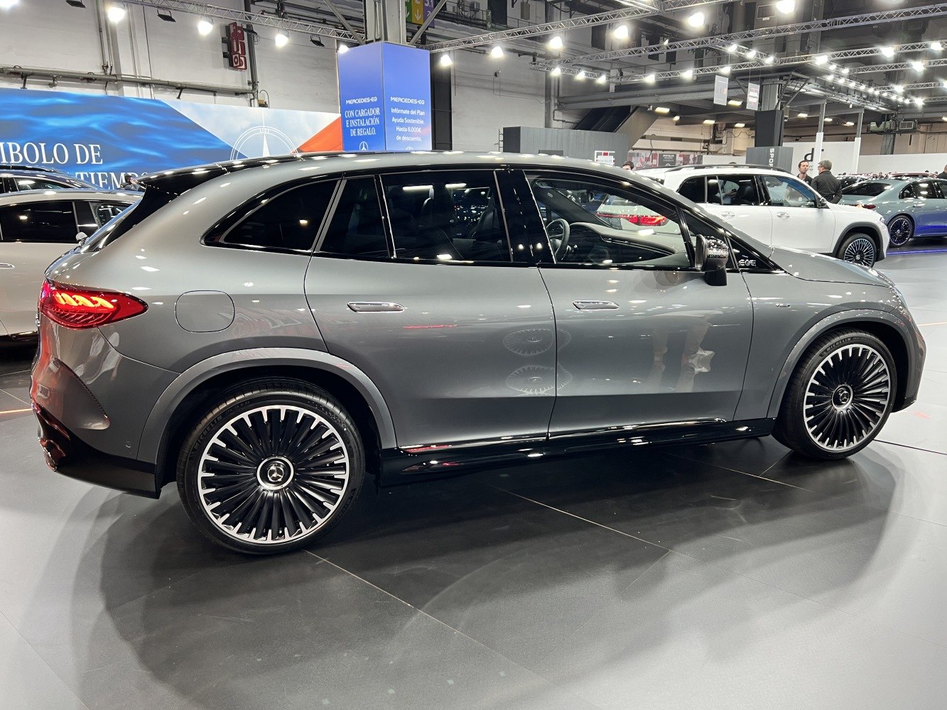 Side view of an aerodynamic SUV with large multi-spoke alloy wheels