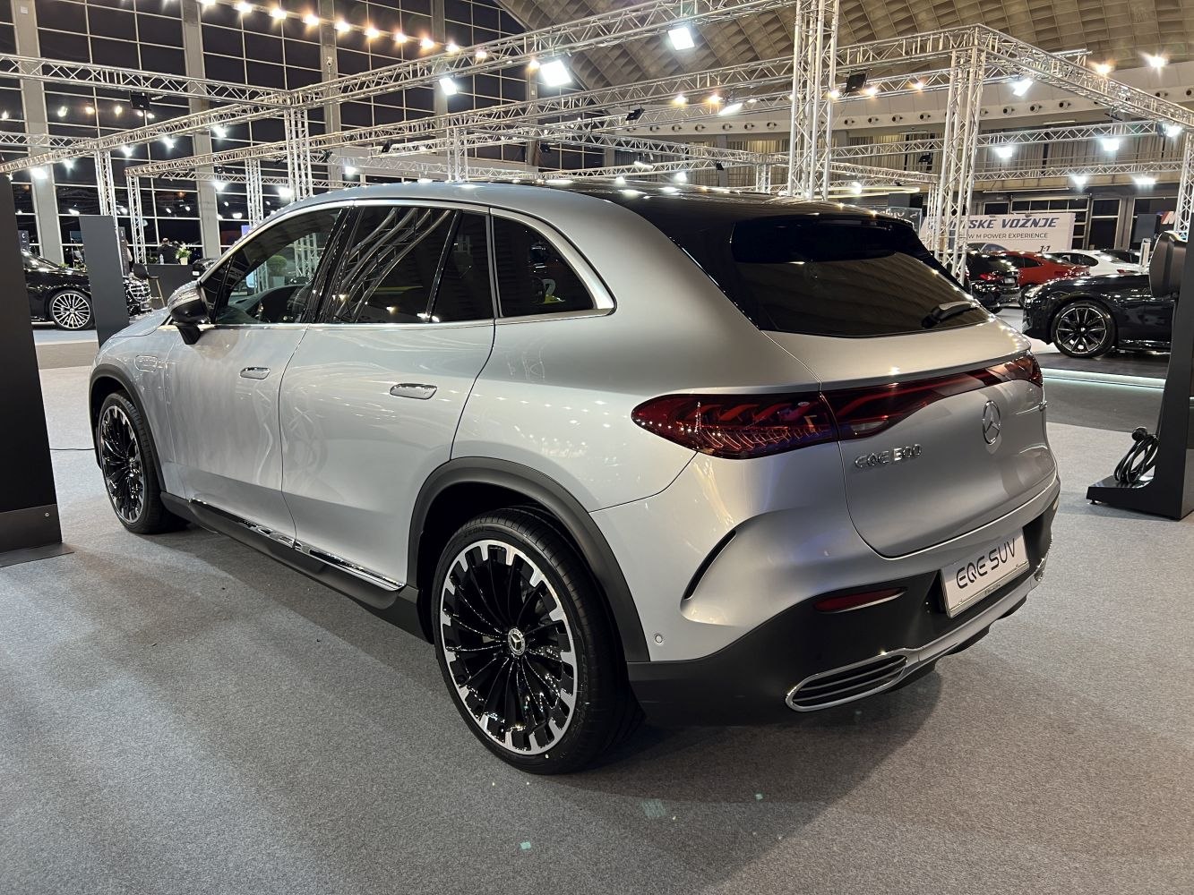 Rear view of electric SUV with sleek taillights and multi-spoke alloy wheels
