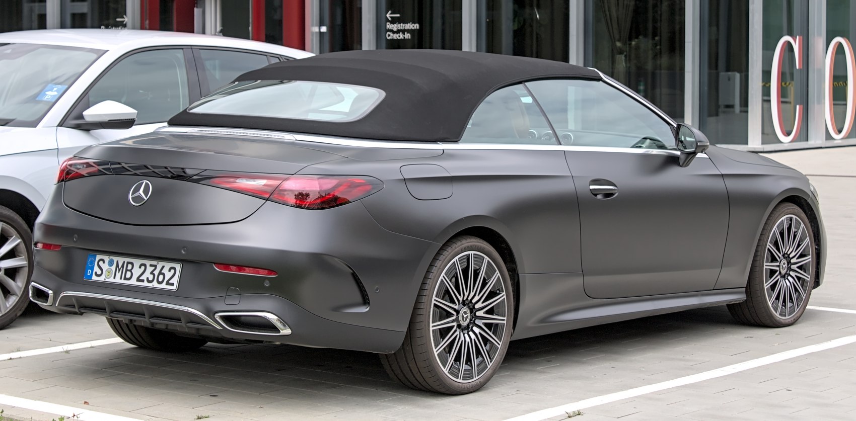 Rear view of a convertible coupe with soft top roof and alloy wheels