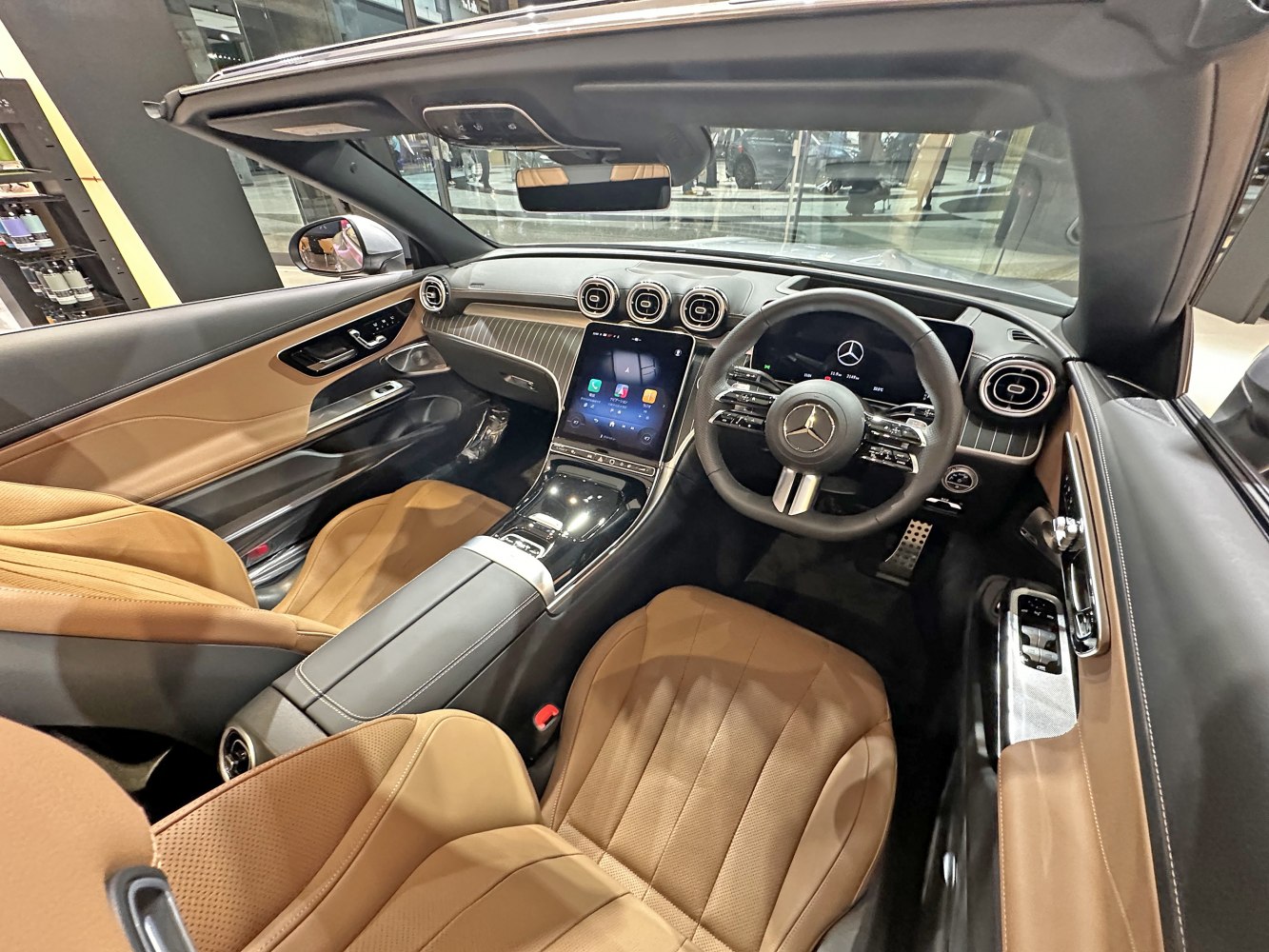 Convertible interior with tan leather seats and digital touchscreen dashboard