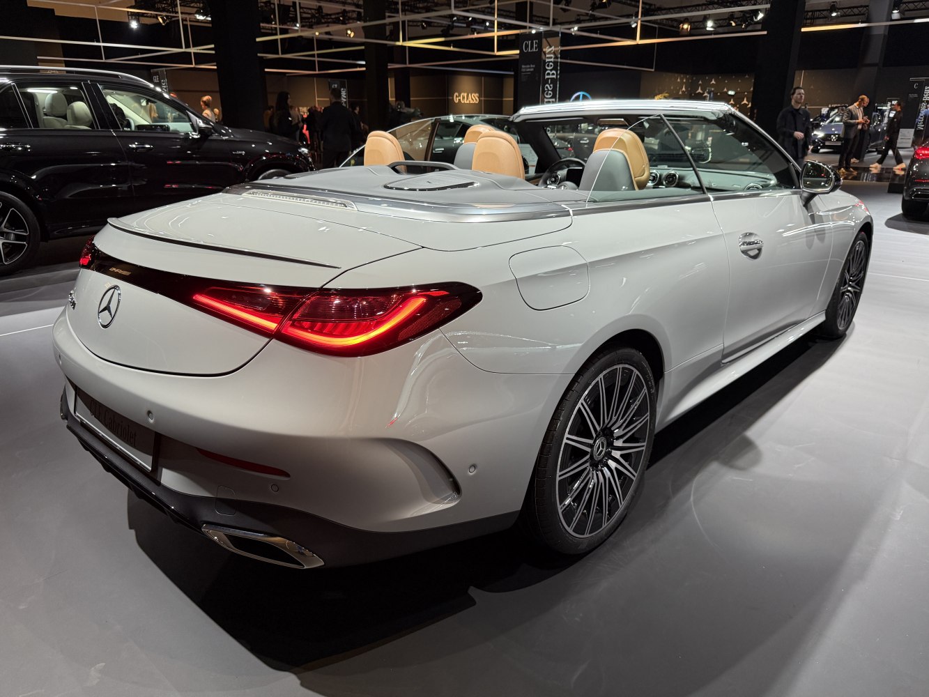 Rear view of convertible with LED taillights and open roof.