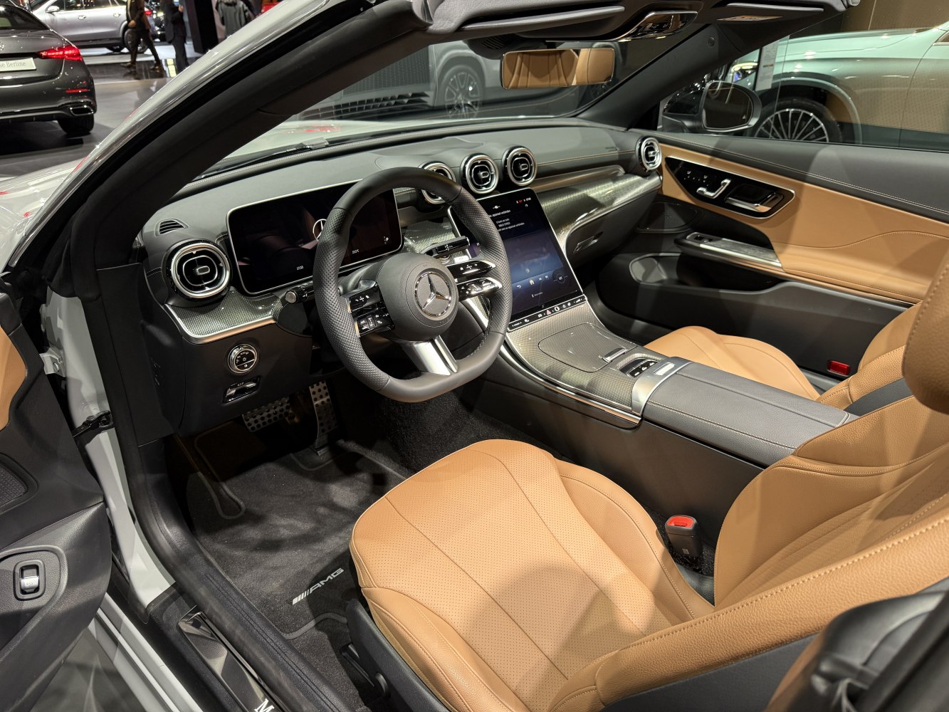 Luxury convertible interior with digital dashboard and tan leather seats