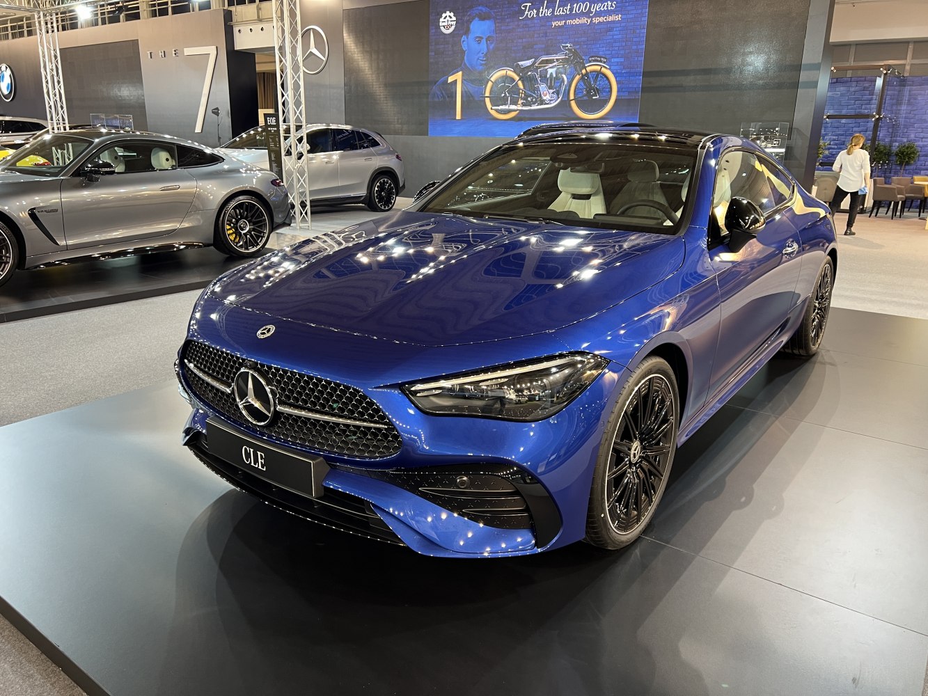 Blue luxury coupe with sculpted front grille and LED headlights