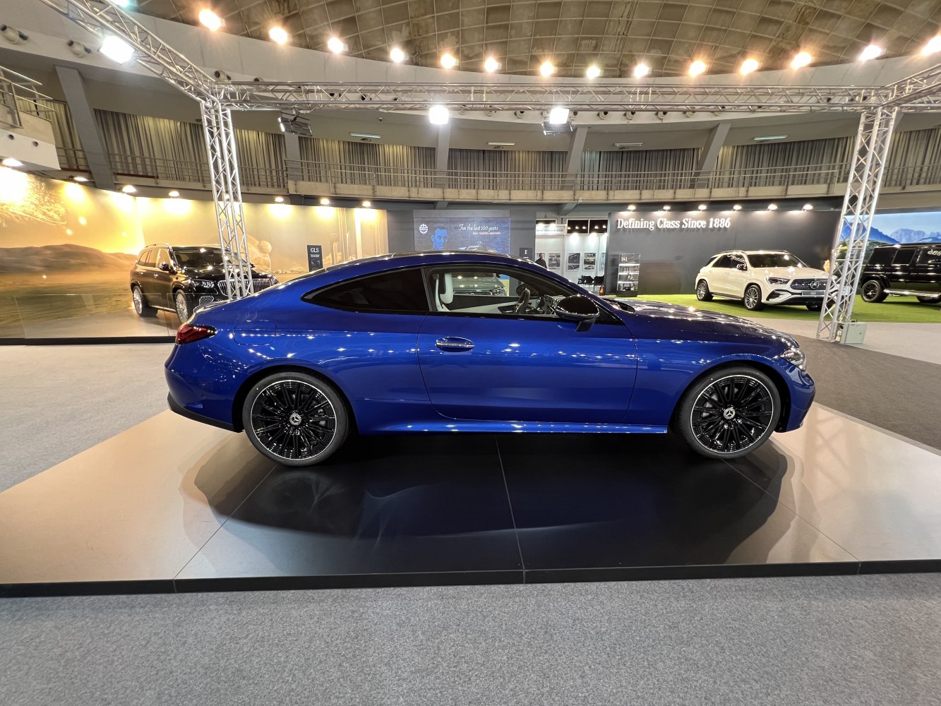 Sleek blue luxury coupe with black multi-spoke alloy wheels