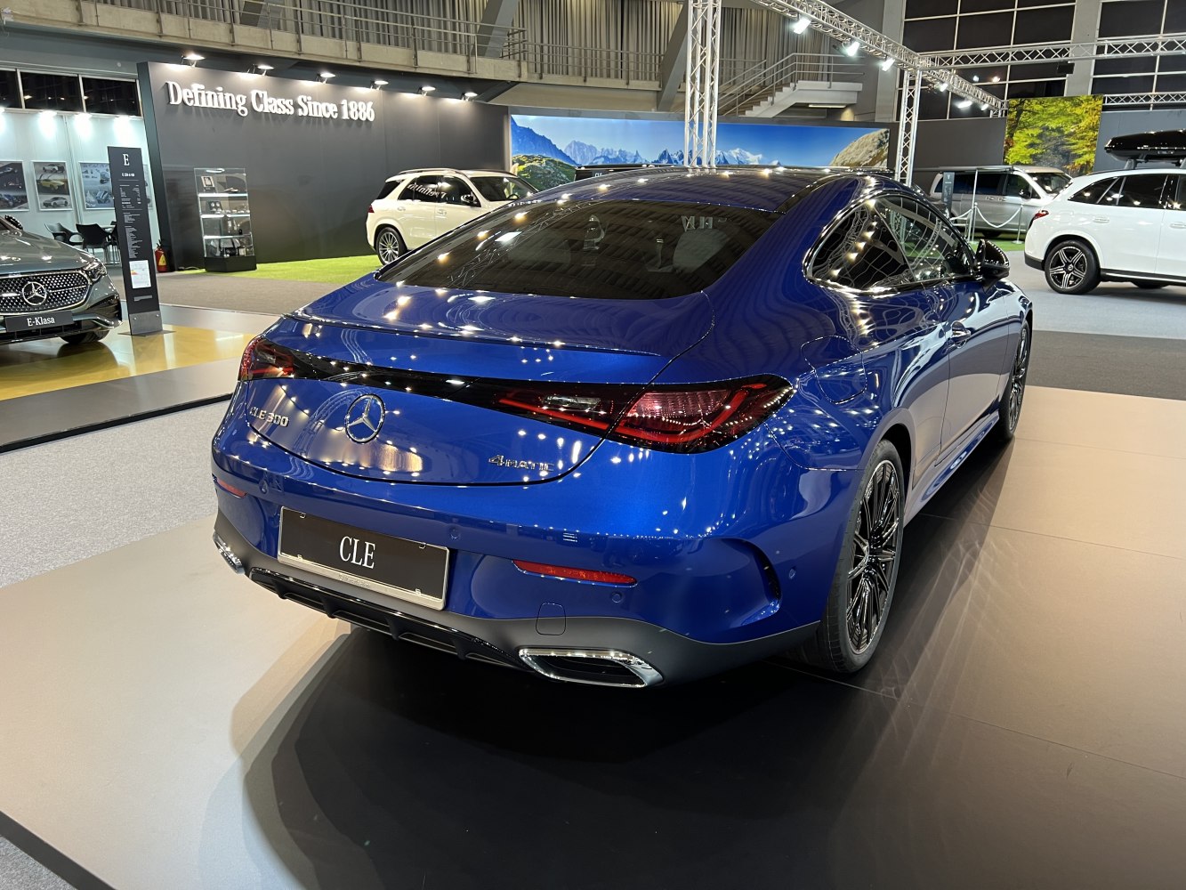 Rear view of a luxury coupe with integrated LED taillights and dual exhausts