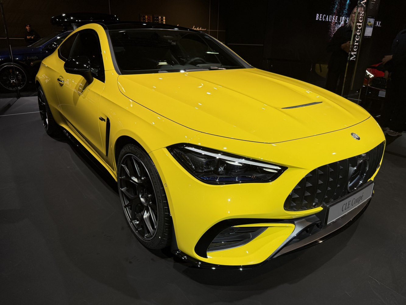 Yellow sports coupe front with aggressive grille and sleek headlights