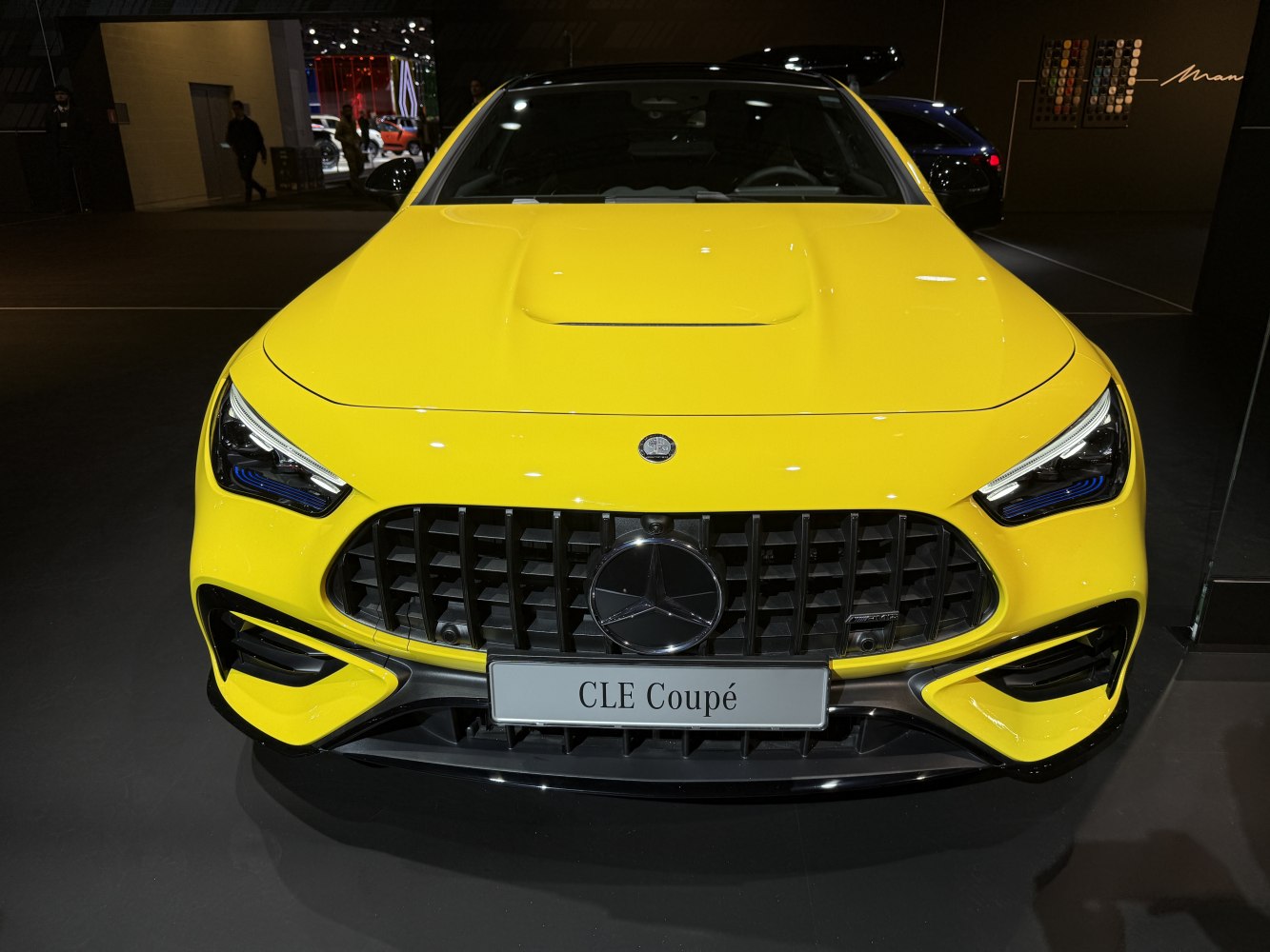 Front close-up of sporty car with AMG grille and sleek headlights