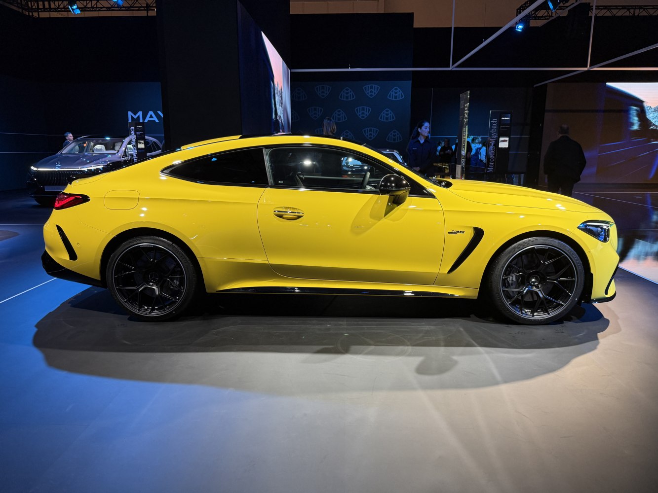 Yellow sports coupe with aerodynamic contours and black multi-spoke alloy wheels
