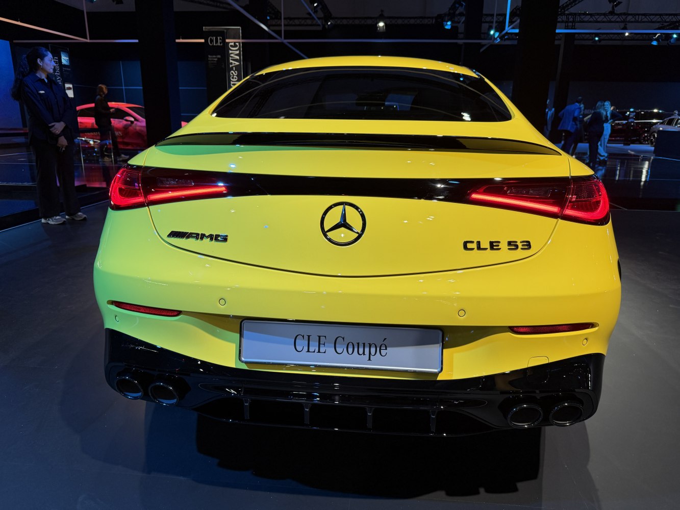 Rear view of yellow luxury coupe with quad exhausts and LED tail lights