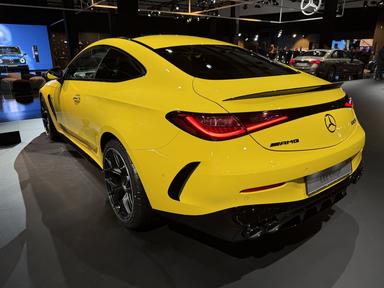 Rear view of yellow coupe with sleek taillights and AMG badging