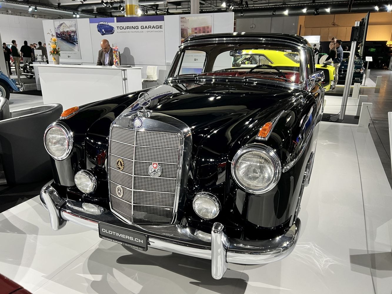 Front grille with badges and round headlights of classic black vintage car