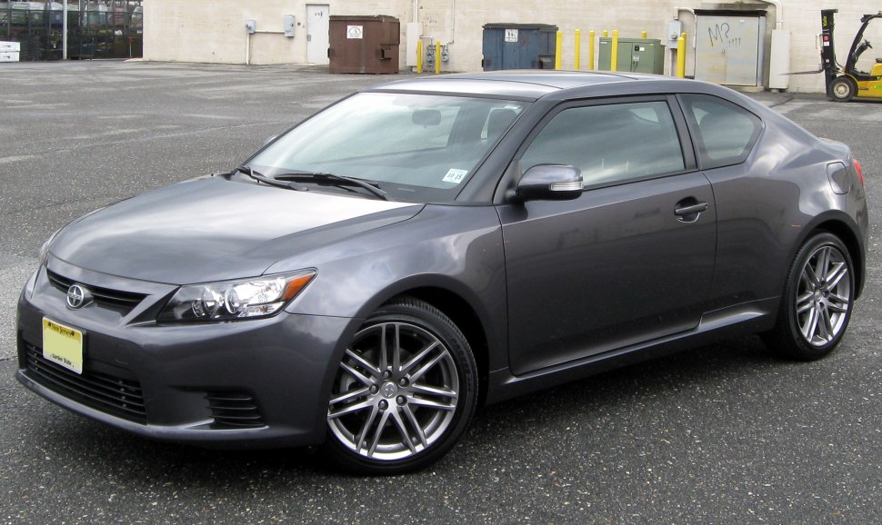Front and side view of a sleek gray coupe with sporty alloy wheels.