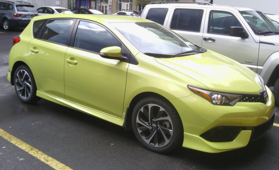 Bright lime green hatchback with sporty alloy wheels and five doors