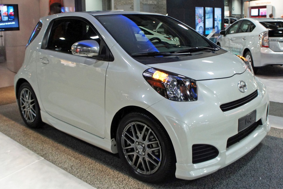 Compact car front view with distinctive headlight and alloy wheels