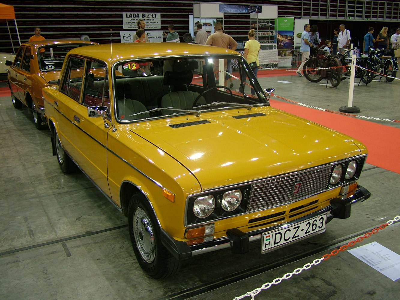 Vintage sedan with quad headlights and chrome grille in yellow
