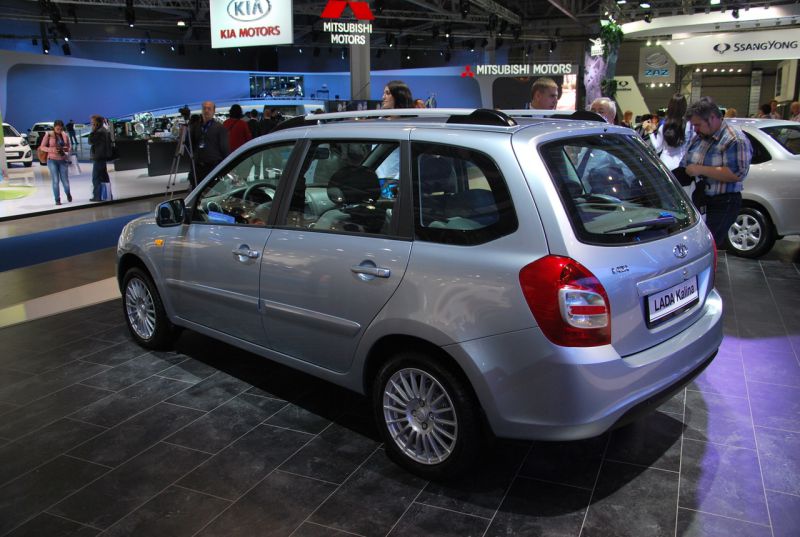 Silver hatchback with rear side view, alloy wheels, four-door design