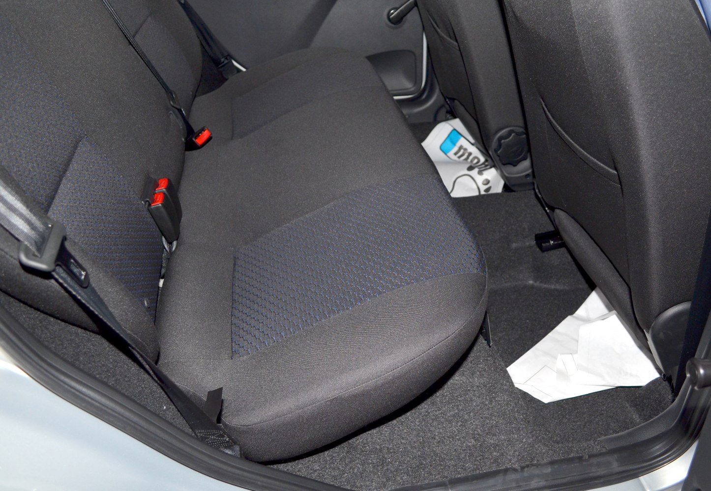 Rear seat fabric upholstery and seatbelts in car interior