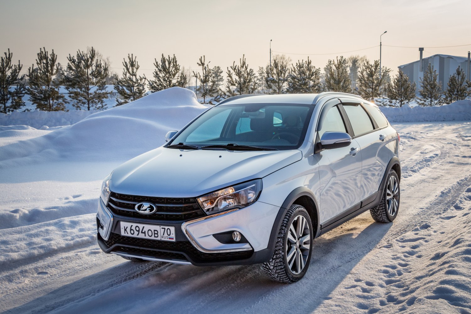 Silver crossover SUV on snowy road with winter tires