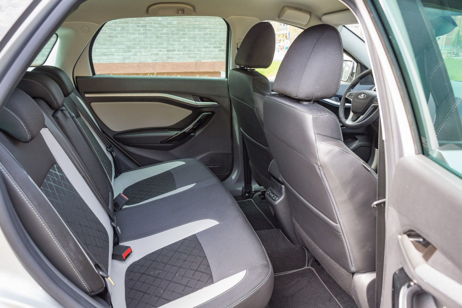 Rear interior seating and door panel with modern upholstery and spacious layout