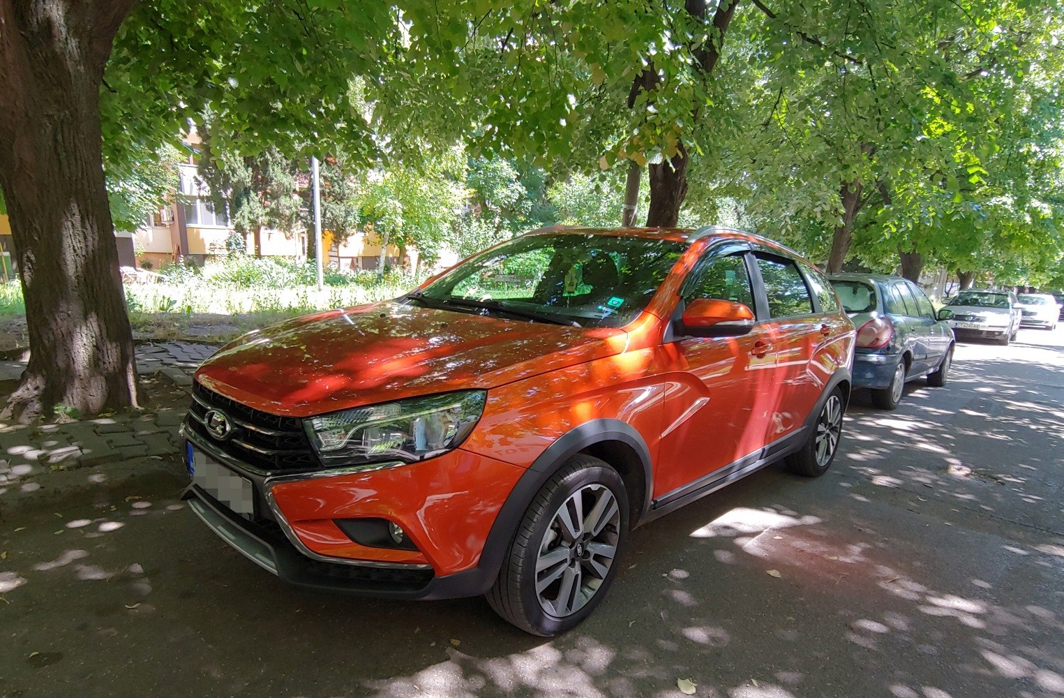 Orange crossover with black wheel arch trim and modern headlights