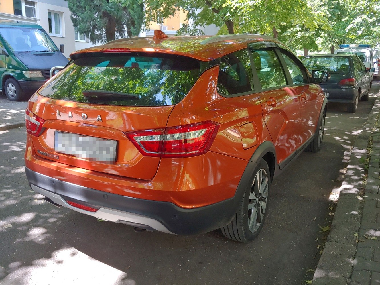 Rear view of orange wagon SUV with black bumper and distinct taillights
