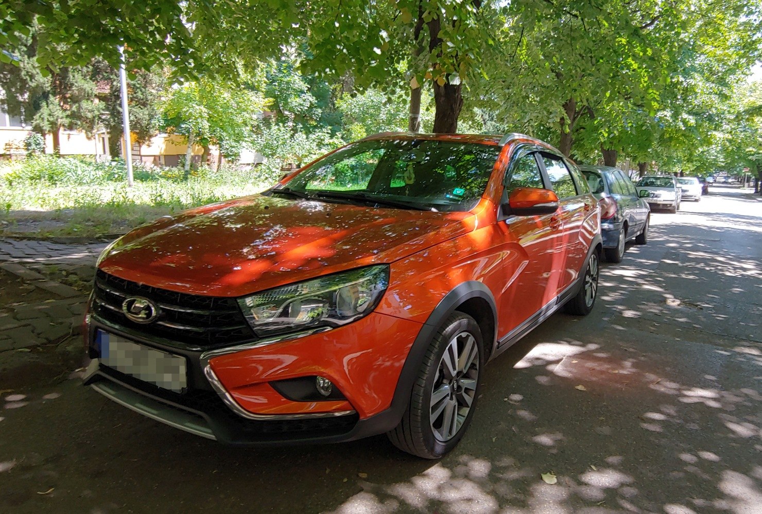 Front and side of an orange compact SUV with alloy wheels