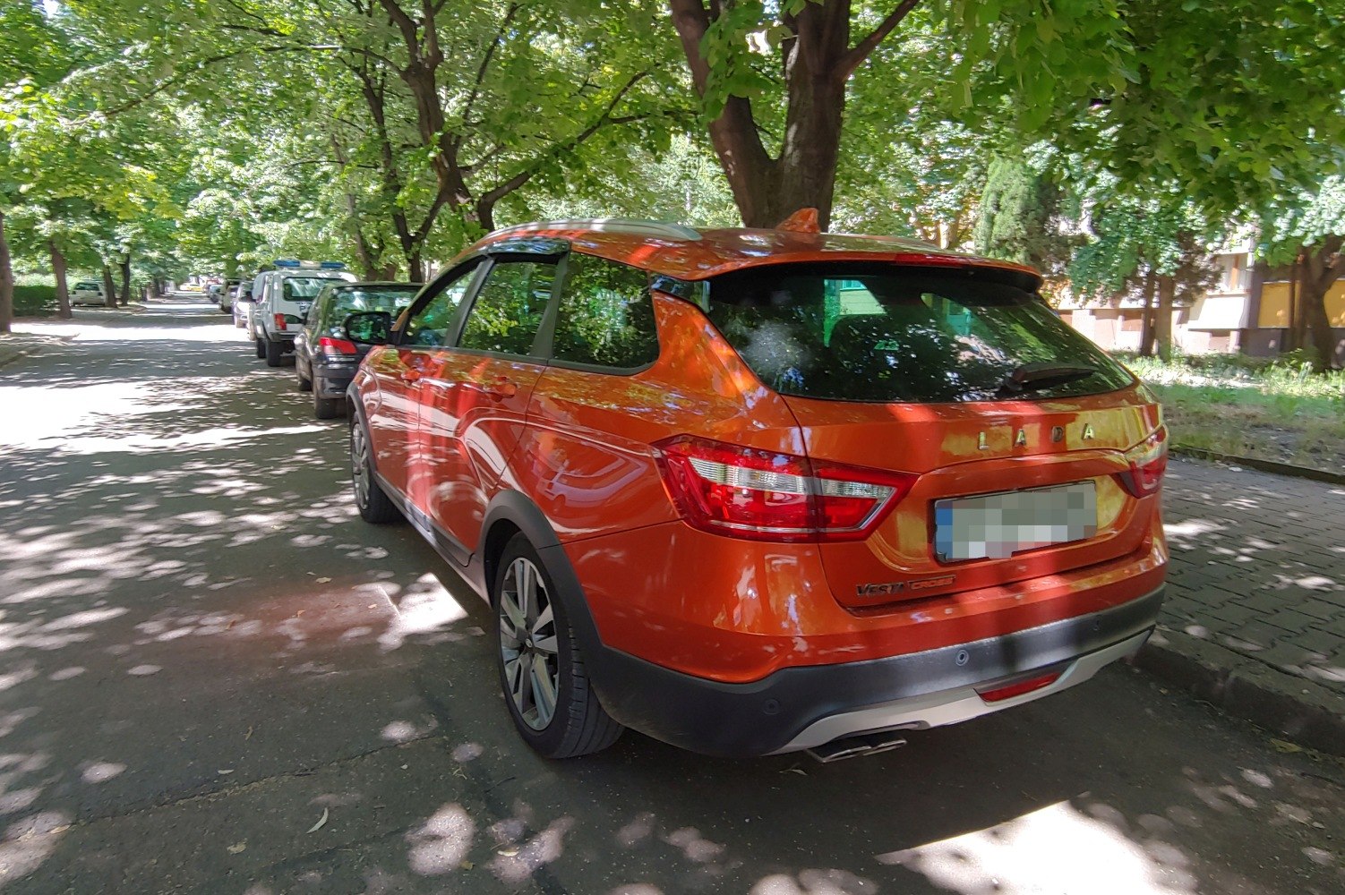Orange hatchback rear with distinctive tail lights and bumper