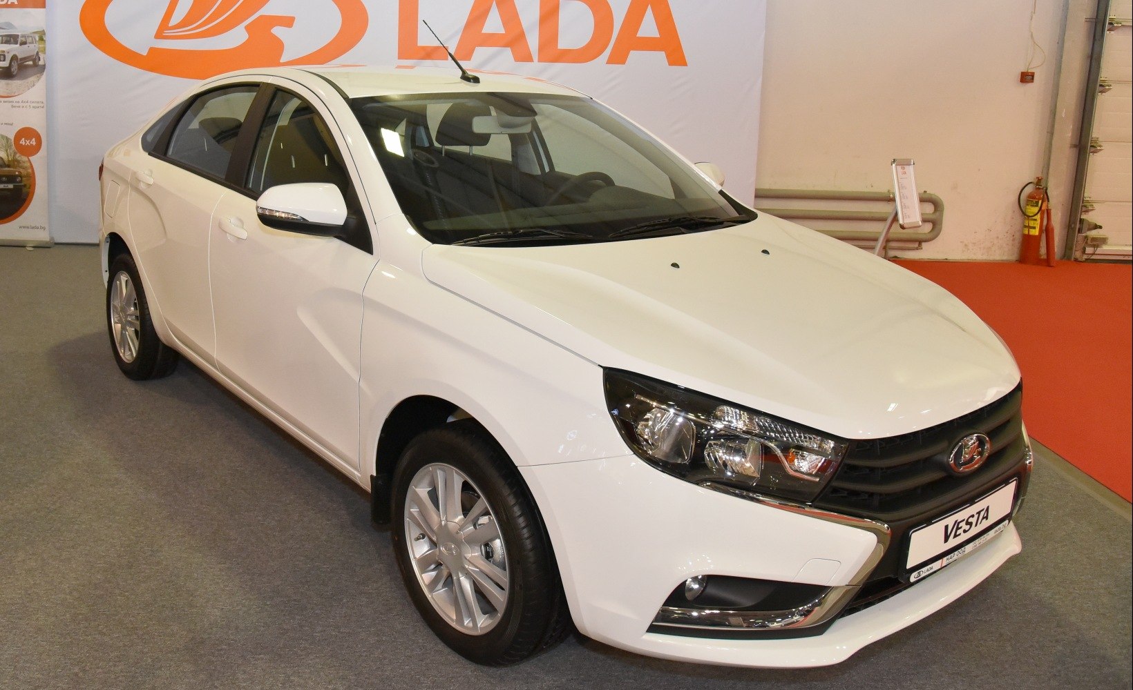 Modern white sedan with sharp headlights and alloy wheels