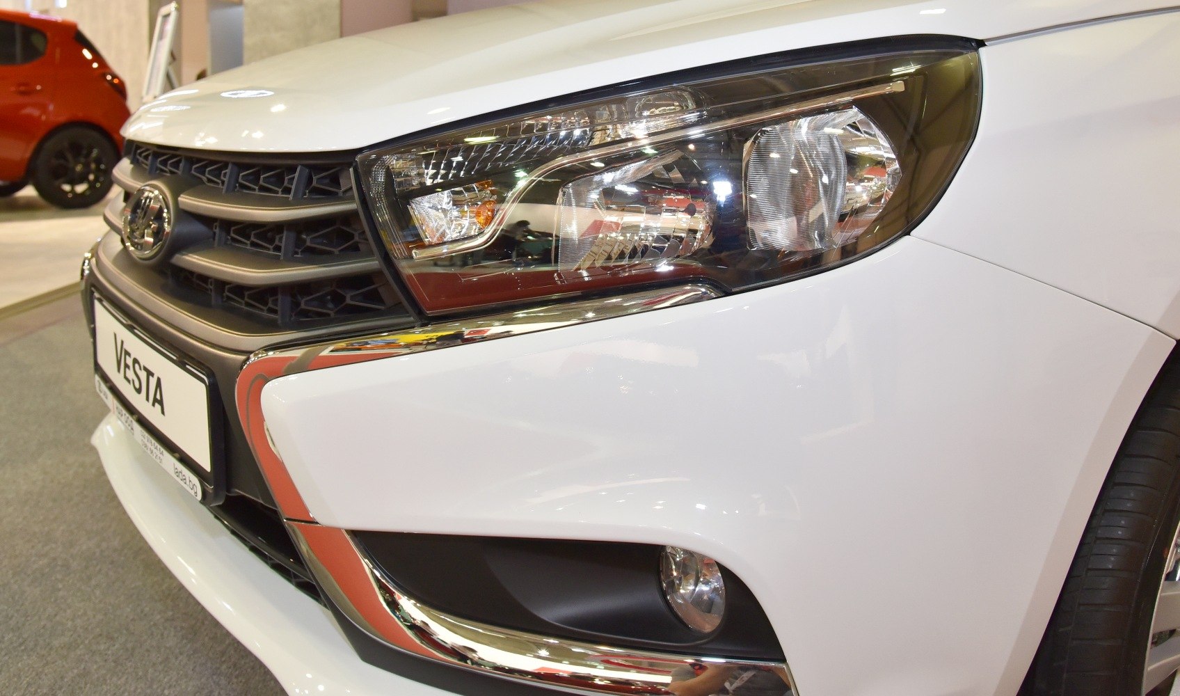 Front grille, headlight, and fog light with chrome trim close-up