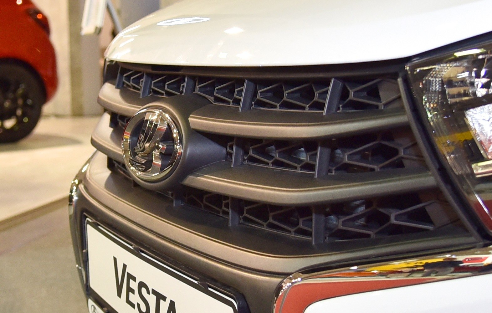 Close-up of front grille with honeycomb pattern and headlight