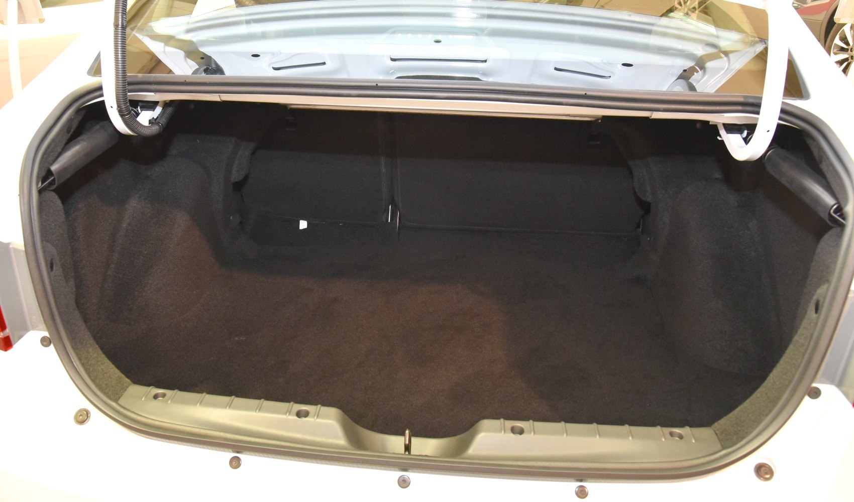 Spacious car trunk with foldable rear seats and carpeted interior