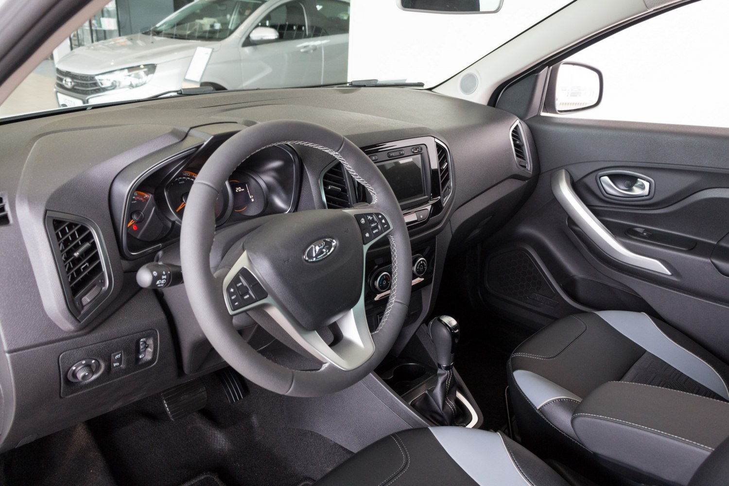 Dashboard, steering wheel, and center console with seats
