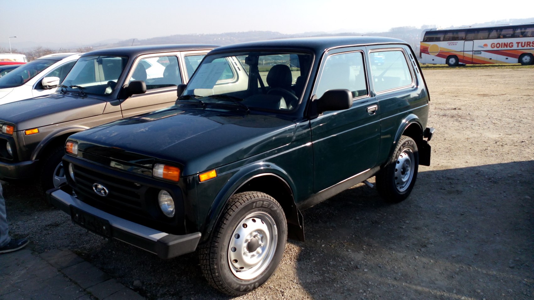 Front and side view of boxy 3-door SUV with steel wheels
