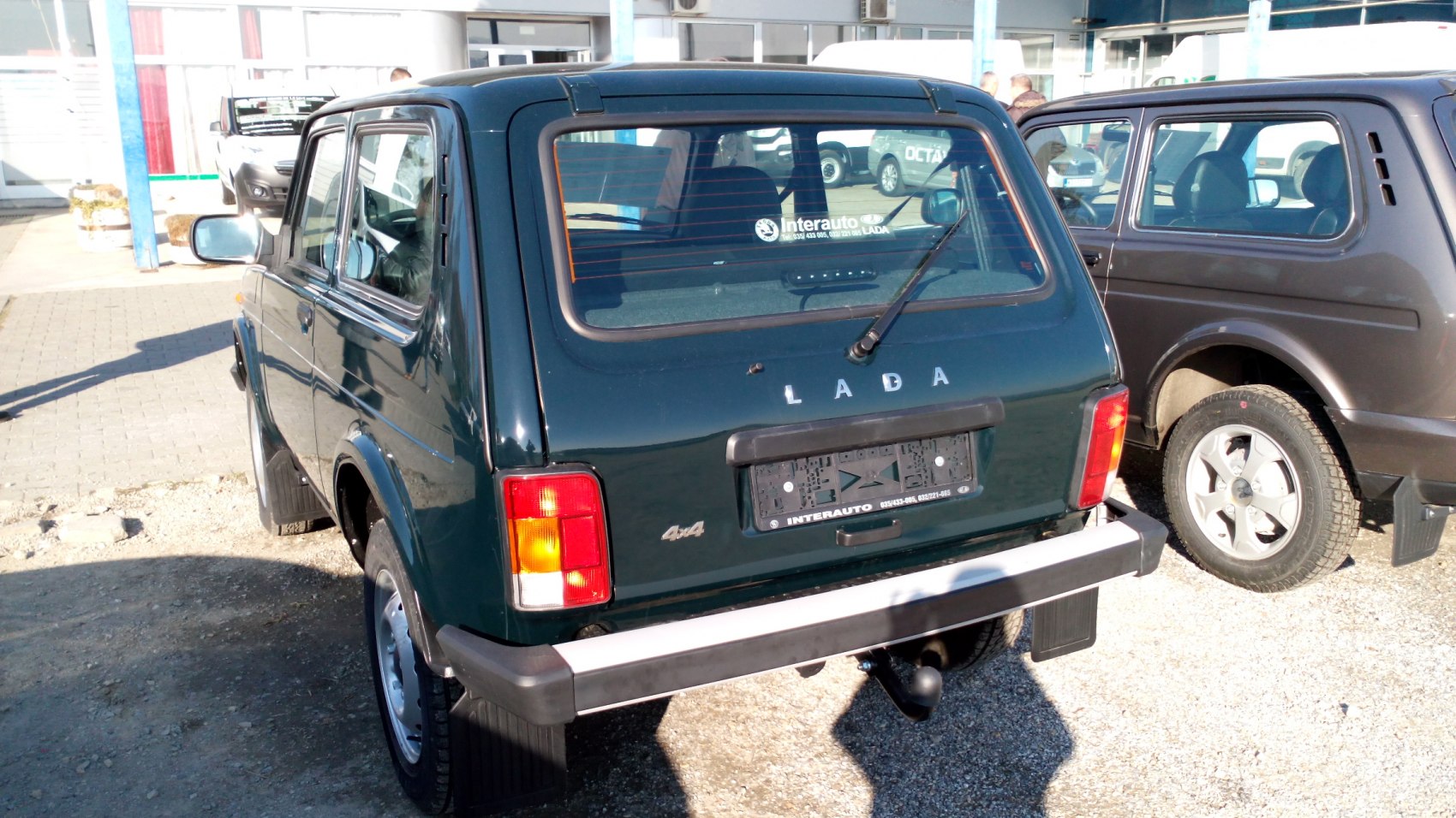 Rear view with 4x4 badge, towhook, tail lights, and side mirror