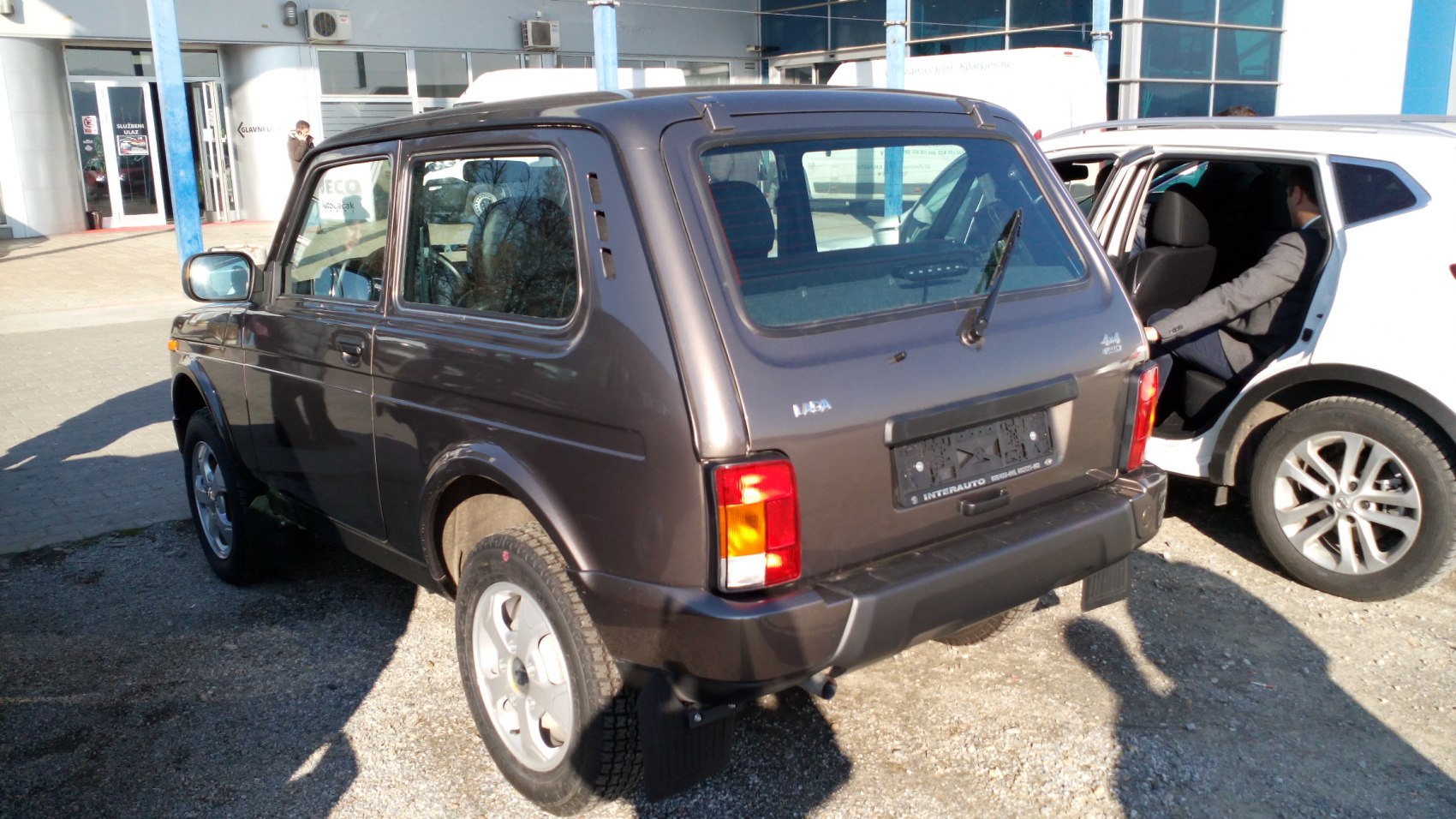 Rear and side view of compact 3-door urban SUV with rear window wiper and alloy wheels